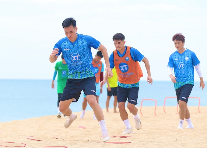 Các cầu thủ Nam Định đang rèn thể lực tại biển Phú Yên. Ảnh: Quang Đương