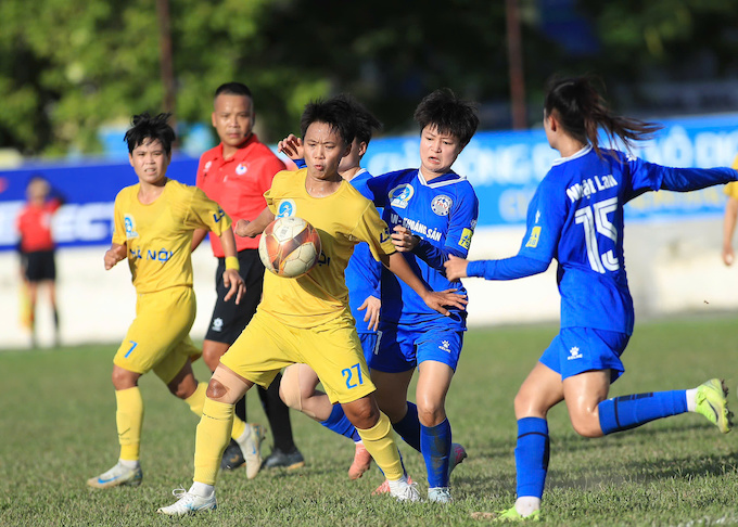 Cuôc so kè quyết liệt giữa cầu thủ Hà Nội (áo vàng) và Than KSVN. Ảnh: Phan Tùng